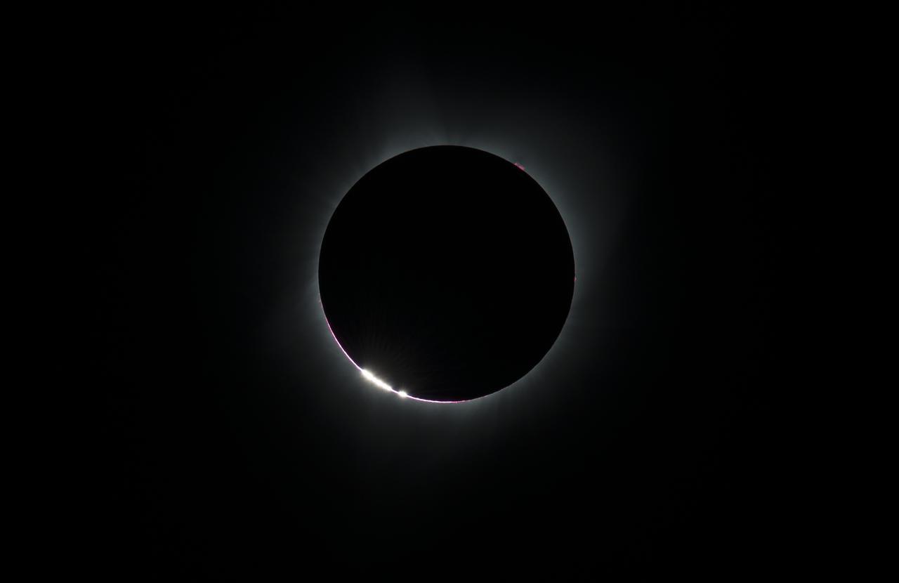 Baily’s beads showing during the 2017 total solar eclipse (bright spots at bottom left of eclipse). Photo credit: NASA.