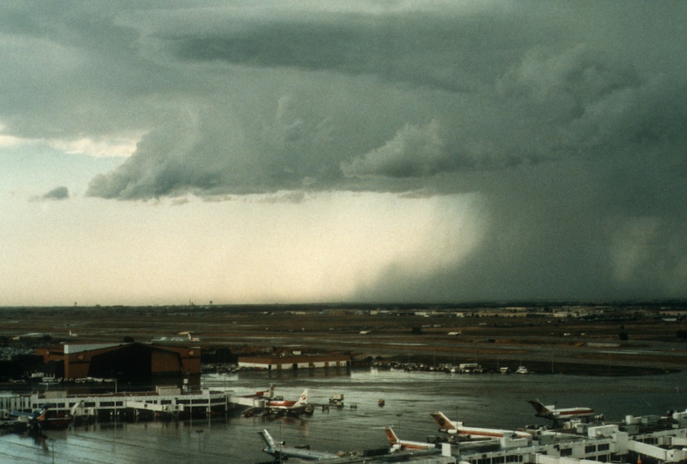 Descending air curls outward and upward as it slams into the ground in a microburst near Denver's former Stapleton International Airport on July 6, 1984, during the CLAWS project (Classify, Locate, Avoid Wind Shear). (Photo by Wendy Schreiber-Abshire, © UCAR).