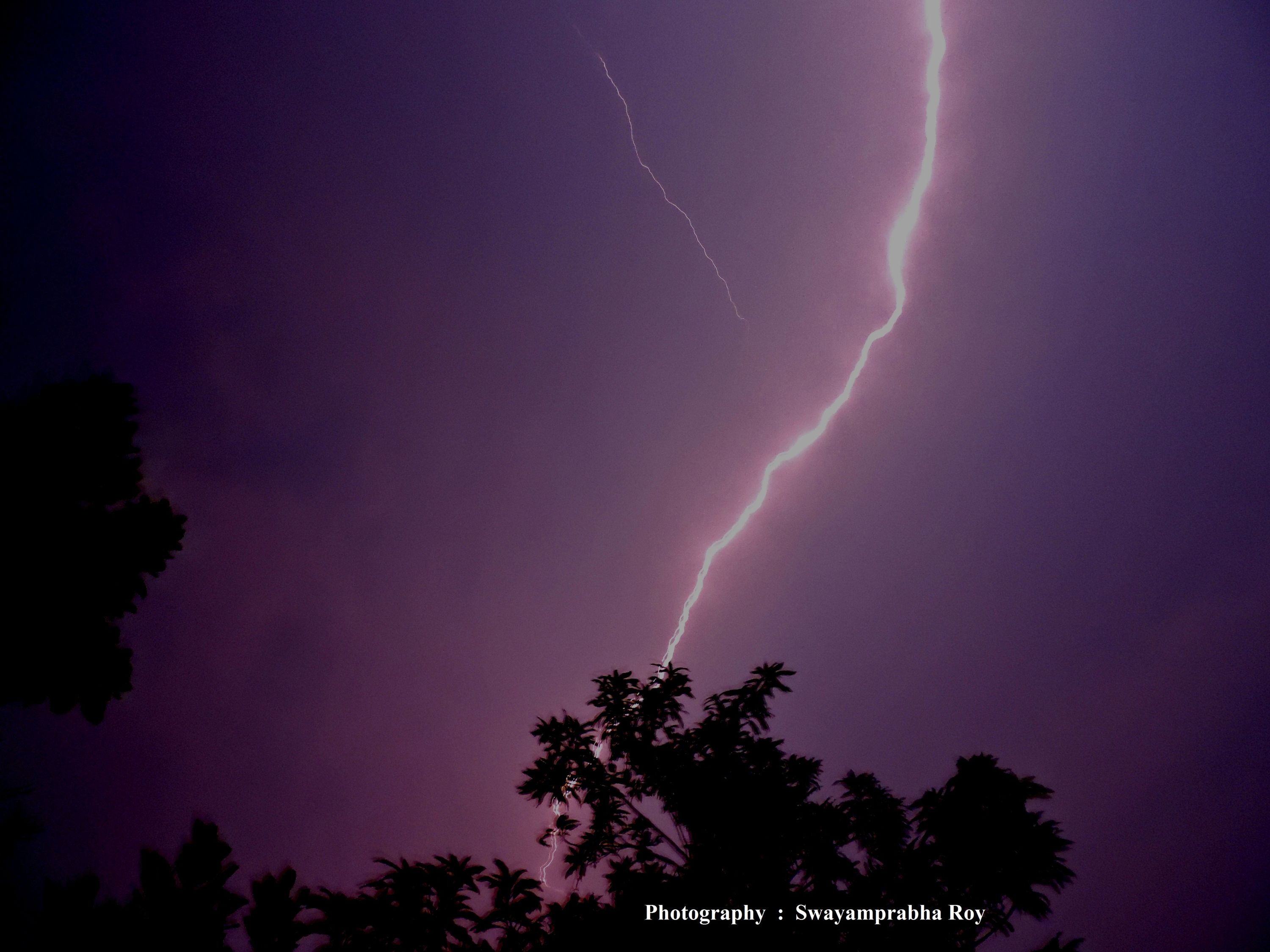 This photograph of lightning bears a meteorological importance with a thrilling beauty showing a very abrupt change of dark sky into a purple one. 